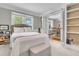 Inviting bedroom with bookshelf, queen size bed and stylish decor featuring a view to the dining room at 1023 Shelley Rd, Charleston, SC 29407