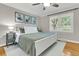 Bedroom featuring a ceiling fan, hardwood floors, and a bright window with blinds at 1023 Shelley Rd, Charleston, SC 29407