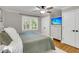 Light-filled bedroom with ceiling fan, TV, white trim, neutral walls, and hardwood floors create a relaxing space at 1023 Shelley Rd, Charleston, SC 29407