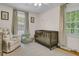 Cozy Bedroom featuring a crib, comfortable seating, ample natural light, and neutral decor at 1023 Shelley Rd, Charleston, SC 29407