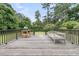 Outdoor deck with grill, seating, and lush greenery providing an excellent space for entertaining at 1023 Shelley Rd, Charleston, SC 29407
