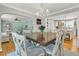 Open dining area with hardwood floors, seating for six, and easy access to the kitchen and living room at 1023 Shelley Rd, Charleston, SC 29407