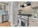 Kitchen featuring stainless steel range, custom hood, white cabinets and mosaic tile backsplash at 1023 Shelley Rd, Charleston, SC 29407