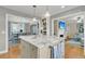 Kitchen island with marble countertop open to living and dining rooms at 1023 Shelley Rd, Charleston, SC 29407