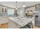 Bright kitchen with white cabinets, marble countertops, stainless steel appliances and kitchen island at 1023 Shelley Rd, Charleston, SC 29407