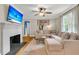Cozy living room featuring fireplace, ceiling fan and large comfortable sofa at 1023 Shelley Rd, Charleston, SC 29407