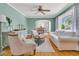 Bright living room with hardwood floors, light-colored furniture, and a view into the dining area at 1023 Shelley Rd, Charleston, SC 29407