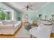 Light and airy living room with hardwood floors, neutral furniture, and large windows at 1023 Shelley Rd, Charleston, SC 29407