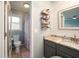 The charming bathroom features granite counters, wood floors, a modern vanity and a nearby shower and toilet at 103 Winston Way, Goose Creek, SC 29445