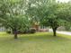 Charming brick home featuring mature trees, green lawn, and a welcoming entrance with a driveway at 103 Winston Way, Goose Creek, SC 29445
