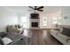 Bright living room featuring a brick fireplace, ceiling fan, and comfortable seating at 103 Winston Way, Goose Creek, SC 29445