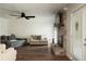 Bright living room featuring a brick fireplace, ceiling fan, and comfortable seating at 103 Winston Way, Goose Creek, SC 29445