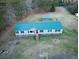An aerial shot highlights the home's green roof and surroundings at 107 Bessie Ln, Bonneau, SC 29431