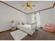 Cozy bedroom featuring a bed, white rug, pink beanbag chair and natural lighting at 107 Bessie Ln, Bonneau, SC 29431