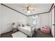Cozy bedroom featuring a bed, white rug, pink beanbag chair and natural lighting at 107 Bessie Ln, Bonneau, SC 29431