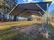 Metal carport on a beautiful lot, offering ample space for parking and outdoor storage at 107 Bessie Ln, Bonneau, SC 29431