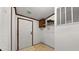 A home entryway with a white door, beige flooring, a small cabinet, and white wire shelving at 107 Bessie Ln, Bonneau, SC 29431