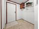 A home entryway with a white door, beige flooring, a small cabinet, and white wire shelving at 107 Bessie Ln, Bonneau, SC 29431