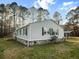 Exterior showcasing siding, green shutters, a covered parking area and a neatly kept lawn at 107 Bessie Ln, Bonneau, SC 29431