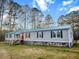 Beautiful property with green roof and shutters offers serene country living at 107 Bessie Ln, Bonneau, SC 29431