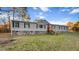 A bright home with a red door and stairs leading to the entrance at 107 Bessie Ln, Bonneau, SC 29431