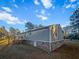 Back view of home features a brick foundation, wooden deck with stairs, and gray vinyl siding at 107 Bessie Ln, Bonneau, SC 29431