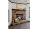 Close up of a stone fireplace featuring decor, hardwood mantle, and a glass-door at 107 Bessie Ln, Bonneau, SC 29431