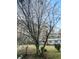 Charming home with a blossoming tree, lush green lawn and red water pump enhancing its curb appeal at 107 Bessie Ln, Bonneau, SC 29431