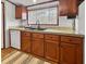 Well-equipped kitchen area showcasing wood cabinetry, a double sink, and ample counter space at 107 Bessie Ln, Bonneau, SC 29431