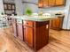 The kitchen island features a flat countertop, and rich wood cabinetry with drawers and base storage at 107 Bessie Ln, Bonneau, SC 29431