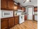Open kitchen with wood-tone cabinetry, white appliances, and ample counter space at 107 Bessie Ln, Bonneau, SC 29431
