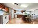 Open kitchen with center island, wood cabinets, appliances, and dining area at 107 Bessie Ln, Bonneau, SC 29431