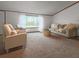 Inviting living room with large windows, comfortable seating, and plenty of natural light at 107 Bessie Ln, Bonneau, SC 29431