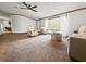 Bright living room with plush carpet, comfortable seating, and a large window view at 107 Bessie Ln, Bonneau, SC 29431