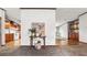 Open living area with sightlines to kitchen and dining, plus neutral paint and carpet at 107 Bessie Ln, Bonneau, SC 29431