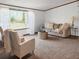 Comfortable living room with large windows and neutral decor, perfect for relaxing at 107 Bessie Ln, Bonneau, SC 29431