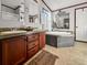 Beautiful bathroom with double sinks, garden tub, and tiled floor at 107 Bessie Ln, Bonneau, SC 29431