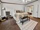 Bright main bedroom with plush bedding, ceiling fan, adjacent bathroom, and stylish accents at 107 Bessie Ln, Bonneau, SC 29431