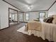 This is a bright main bedroom with a ceiling fan and a large closet with mirrored doors at 107 Bessie Ln, Bonneau, SC 29431