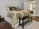 Bright main bedroom with plush bedding, ceiling fan, adjacent bathroom, and stylish accents at 107 Bessie Ln, Bonneau, SC 29431