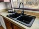 Close up of the kitchen sink featuring modern black faucet and black double basin at 107 Bessie Ln, Bonneau, SC 29431