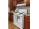 White ceramic top electric stove with gray towel hanging on oven door and silver backsplash at 107 Bessie Ln, Bonneau, SC 29431