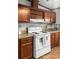 Close up of white ceramic top electric stove with backsplash, cabinets and range hood at 107 Bessie Ln, Bonneau, SC 29431