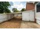 Fenced storage area next to a brick home, offering privacy and utility in the backyard at 1100 Cass Dr, Moncks Corner, SC 29461
