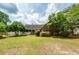 Charming backyard featuring brick exterior, screened-in porch, and mature landscaping at 1100 Cass Dr, Moncks Corner, SC 29461