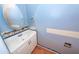 Powder room features a white vanity, brushed nickel hardware, and blue painted walls at 1100 Cass Dr, Moncks Corner, SC 29461