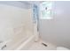 Bright bathroom with tile floor and shower-tub combo at 1100 Cass Dr, Moncks Corner, SC 29461