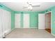 Bedroom with bright teal walls, ceiling fan, and carpeted floors at 1100 Cass Dr, Moncks Corner, SC 29461