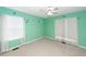 Bedroom with bright teal walls, ceiling fan, and carpeted floors at 1100 Cass Dr, Moncks Corner, SC 29461