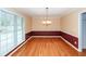 Bright dining room with hardwood floors, a classic chandelier, and large windows for natural light at 1100 Cass Dr, Moncks Corner, SC 29461